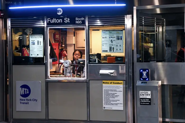 A subway station booth agent works at Fulton Center in Manhattan.